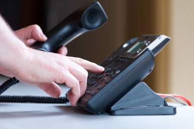 A person dialling a phone number